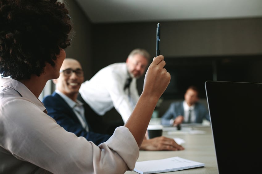 Woman Asking a Query during a Meeting